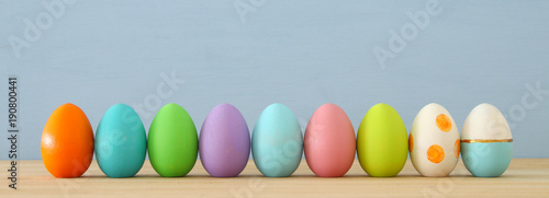 Top view of easter colorful eggs over blue background.