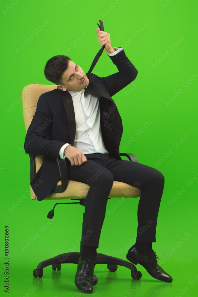 The businessman hanging himself for a tie on the green background Stock  Photo | Adobe Stock