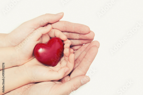Fototapeta Naklejka Na Ścianę i Meble -  Parent and child holding heart in hand