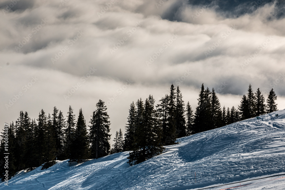 Fototapeta premium Snow on the top of the mountains and fog down the valley
