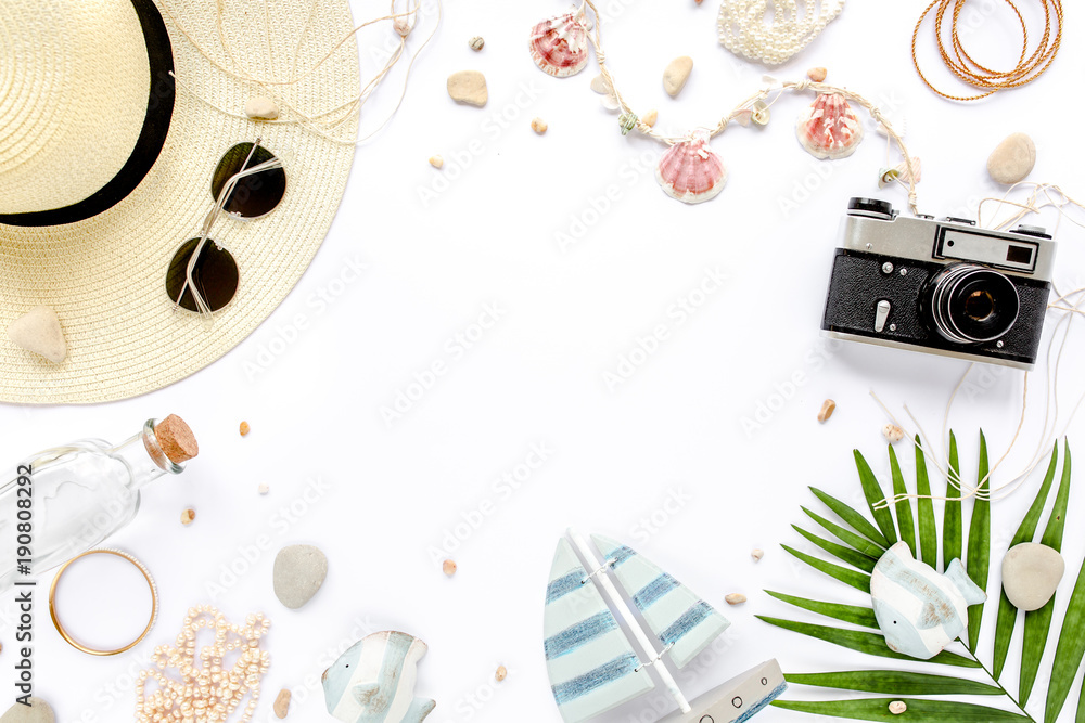 Obraz premium Traveler accessories, tropical palm leaf branches, camera on white background with empty space for text. Travel vacation concept. Summer background. Road frame set. Flat lay, top view.