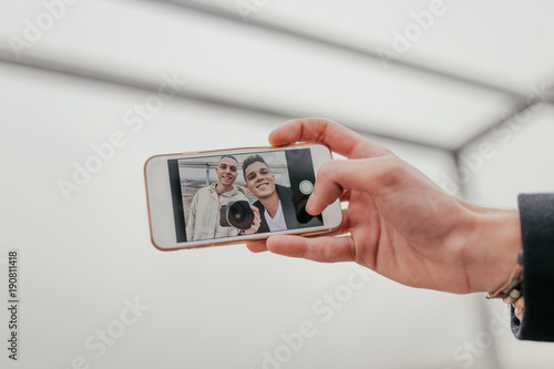 Two young handsome guys taking a selfie