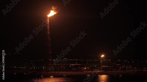 Flare stack of petrochemical refinery in the night