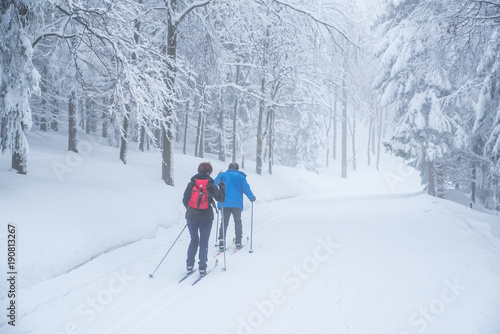 Retire couple have active time in white snowy winter nature, old people sports together