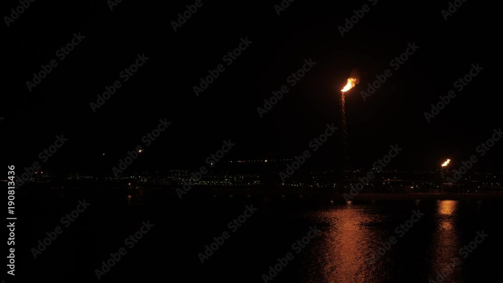 Flare stack of petrochemical refinery in the night Flare stack of petrochemical refinery in the night