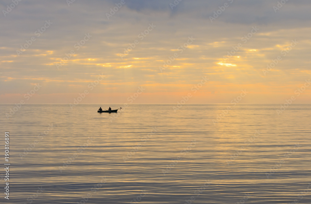 Two fishermen in a boat.