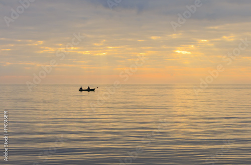 Two fishermen in a boat.