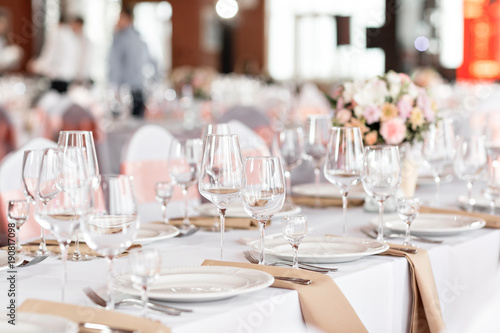 Tables set for an event party or wedding reception. luxury elegant table setting dinner in a restaurant. glasses and dishes.