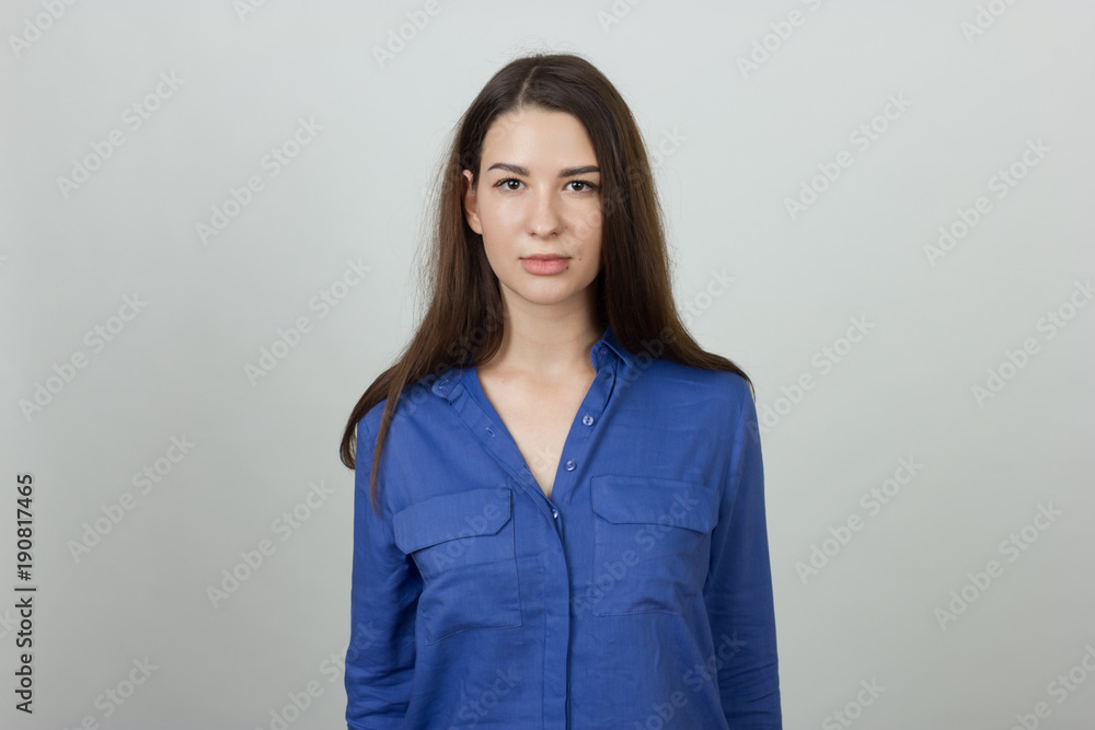 Portrait of a pretty woman standing over gray background Portrait of a pretty woman standing over gray background