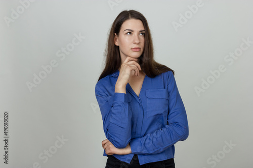 Woman thinks on a gray background