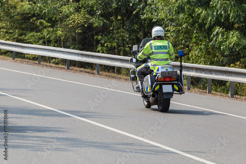Policeman riding on a motorbike, rear view © michalsanca