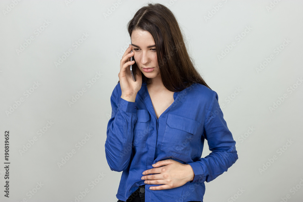 Portrait of a pretty woman with stomach issues calling a doctor Portrait of a pretty woman with stomach issues calling a doctor