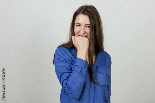 Young Girl is biting her fist