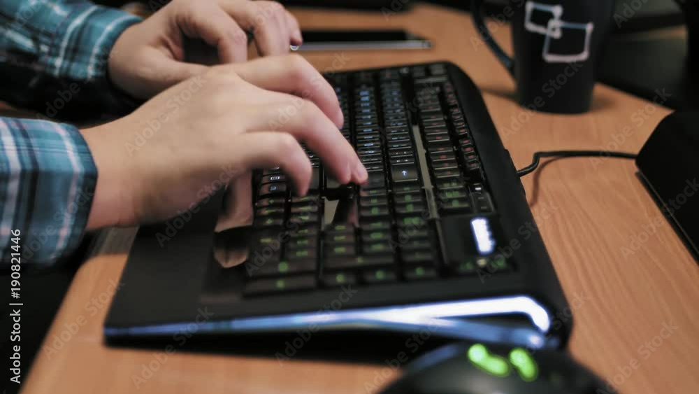Man typing on modern illuminated computer keyboard. Man typing on modern illuminated computer keyboard.