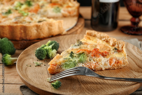 Plate with tasty broccoli quiche on table