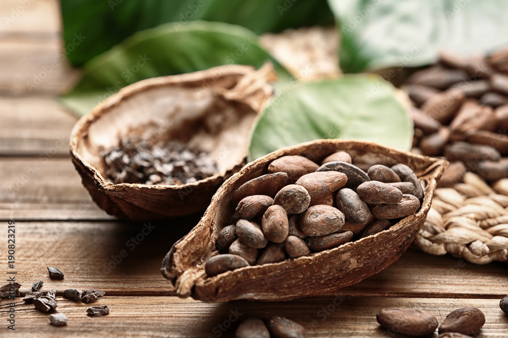 Ripe cocoa pod with beans on wooden background Ripe cocoa pod with beans on wooden background