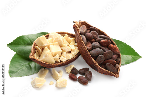 Halves of ripe cocoa pod with beans and butter on white background