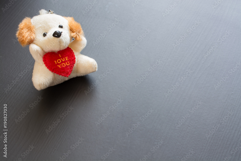 Soft plush toy dog with heart.