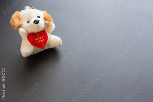 Soft plush toy dog with heart.