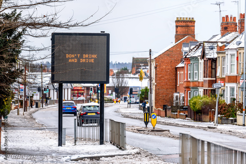 Cloudy Day Winter View of modern information sign with words Do Not Drink and Drive on Typical English road under snow photo