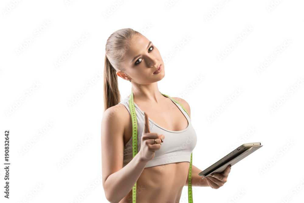 Fitness trainer with laptop and tape-measure shot Fitness trainer with laptop and tape-measure shot