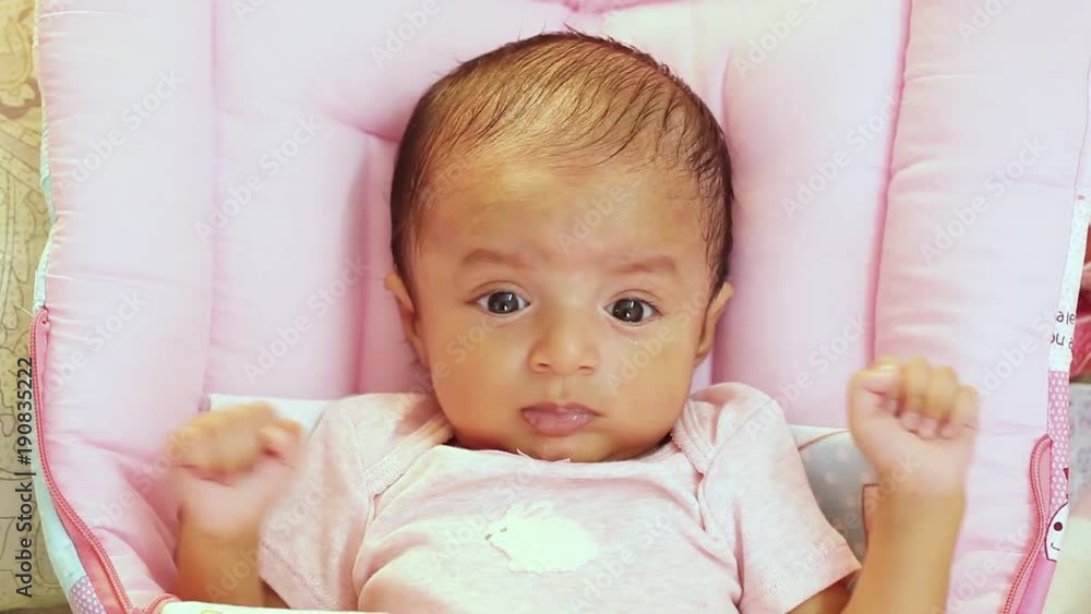 Newborn baby closeup,playful,active,smiling Newborn baby closeup,playful,active,smiling