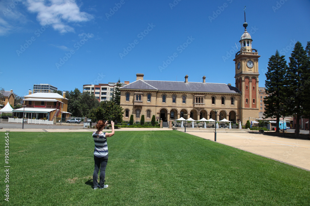 Tourist taking a photo of the historic architecture in  Newcastle Australia - Customs House