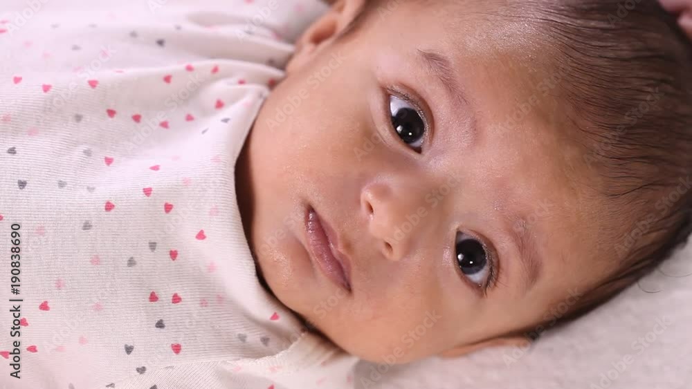 Newborn baby close up,playful,active,smiling Newborn baby close up,playful,active,smiling