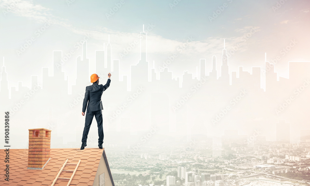 Man architect draw silhouette of modern city on blue sky. Mixed Man architect draw silhouette of modern city on blue sky. Mixed