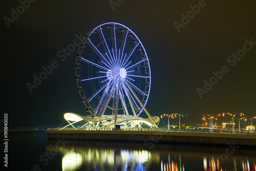 Ferris wheel in the night landscape. Evening Baku, Azerbaijan