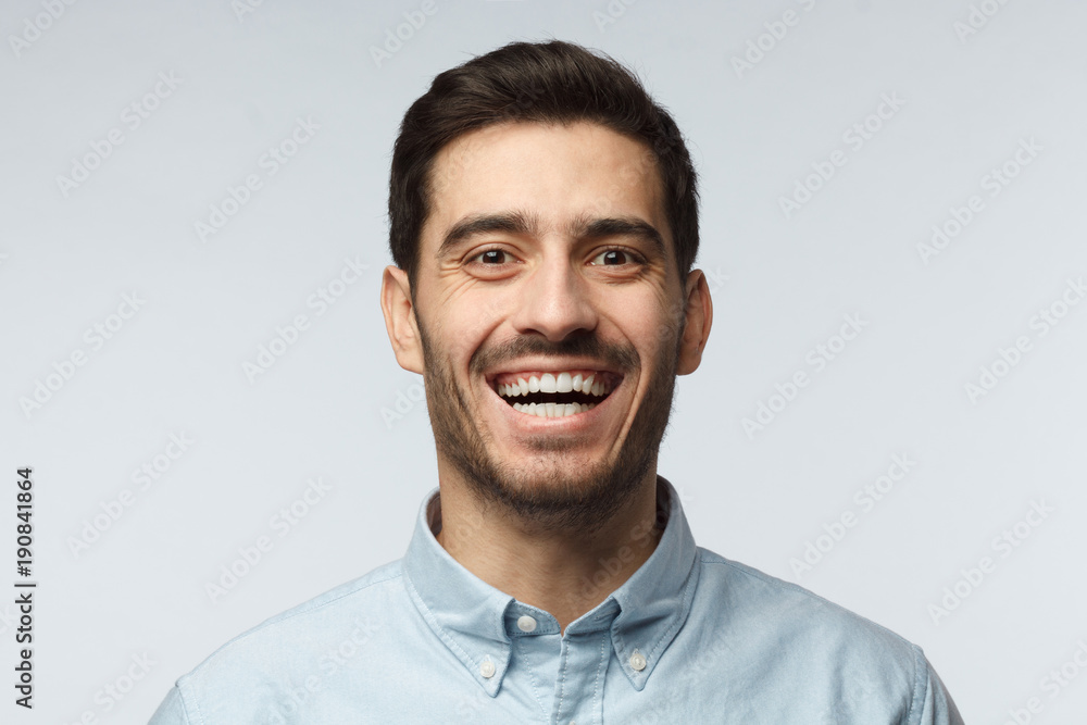 Joyful modern optimistic business man smiles broadly, shows white perfect teeth. Positive emotions, facial expressions and happiness concept. Joyful modern optimistic business man smiles broadly, shows white perfect teeth. Positive emotions, facial expressions and happiness concept.