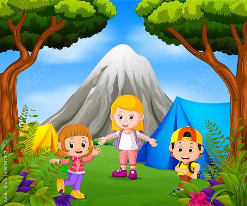 Children camping out in the park with mountain scene