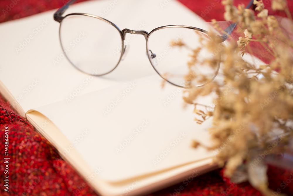 Fototapeta premium Closeup of book, glasses and autumn leaves, relax or other romantic concept
