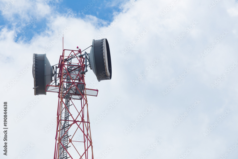 Communication Tower with antenna and satellite dish telecom network on blue sky background.