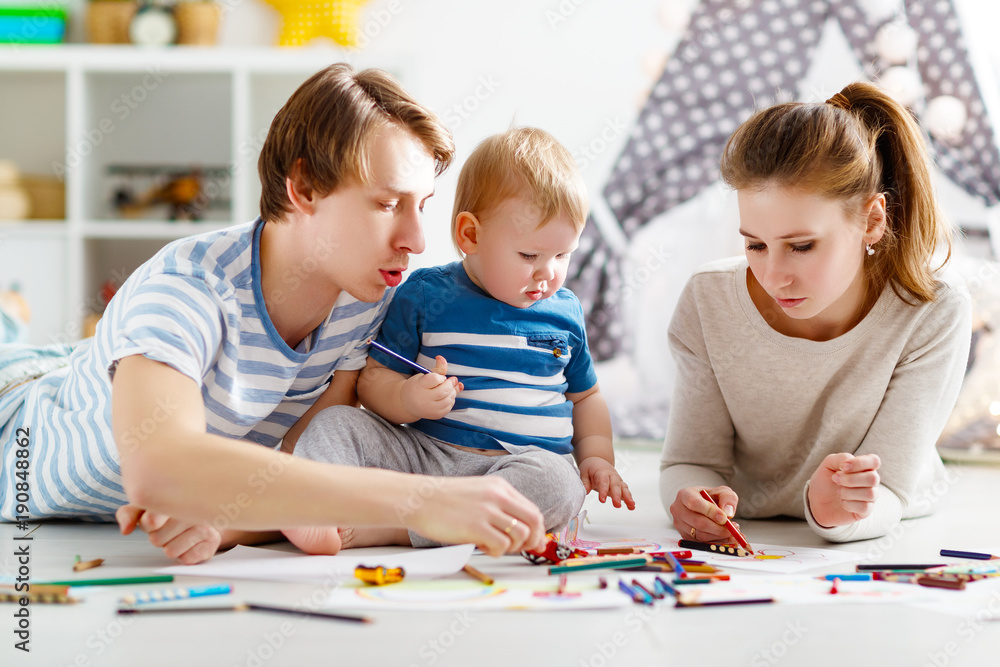 children's creativity. happy family mother father and son draw together children's creativity. happy family mother father and son draw together