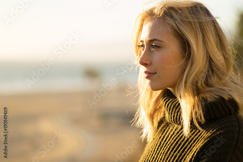 Young caucasian woman looking far away thinking