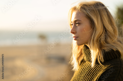 Young caucasian woman looking far away thinking
