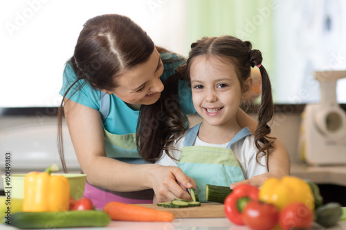 Woman and kid girl preparin...