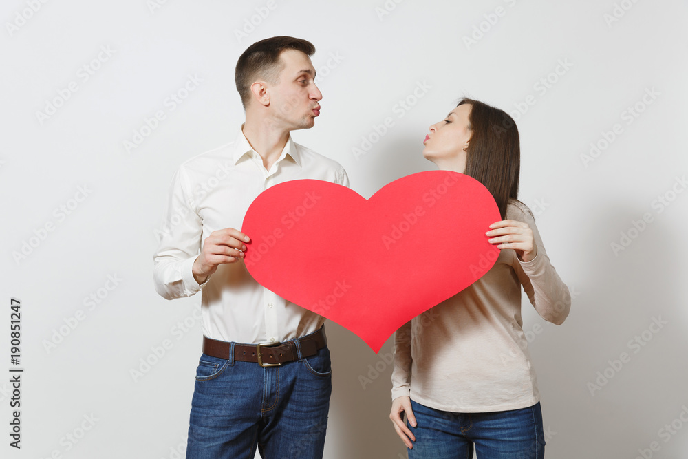 Couple in love. Man and woman with big red heart isolated on white background. Copy space for advertisement. With place for text. St. Valentine's Day International Women's Day birthday holiday concept