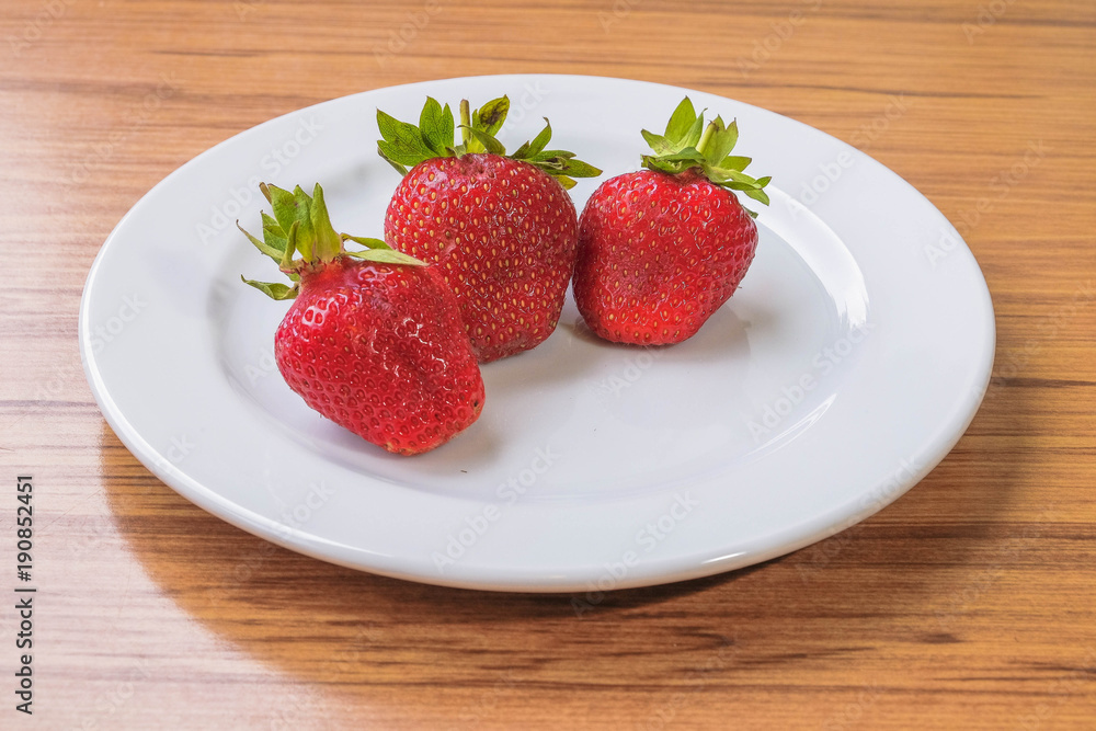 Fresh strawberry on a white plate Fresh strawberry on a white plate