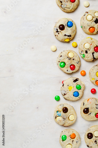 Homemade Cookies with Colorful Chocolate Candies on Bright Background, Copy Space