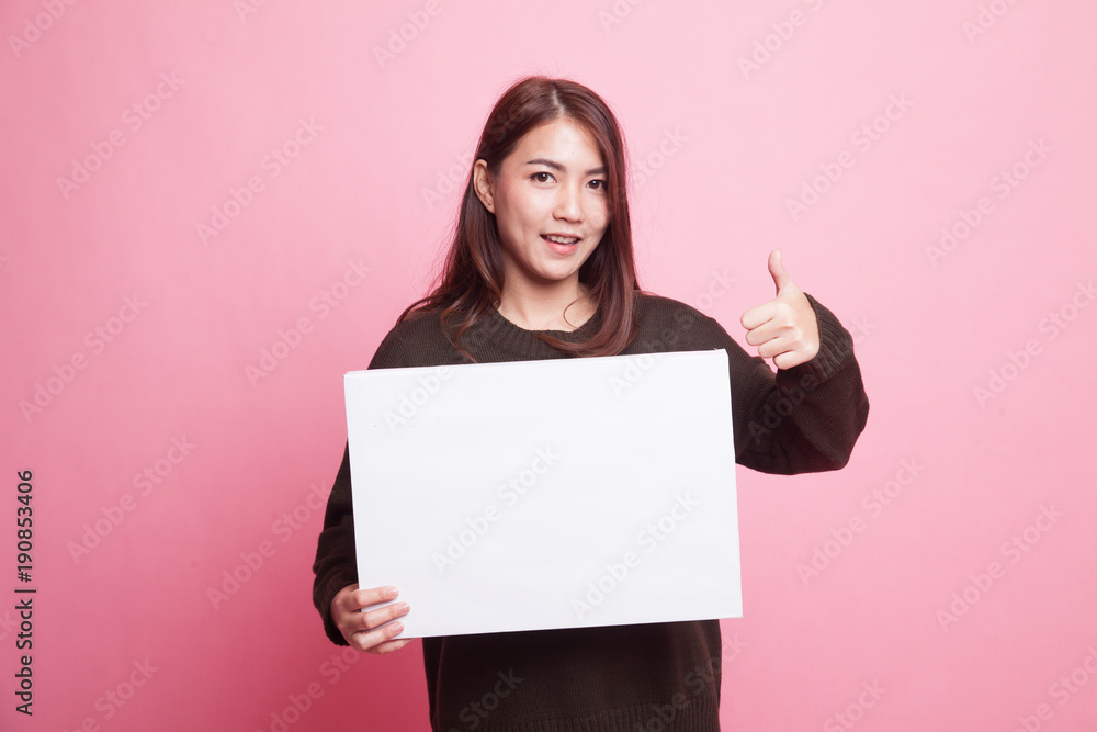 Young Asian woman show thumbs up with  white blank sign. - obrazy, fototapety, plakaty 