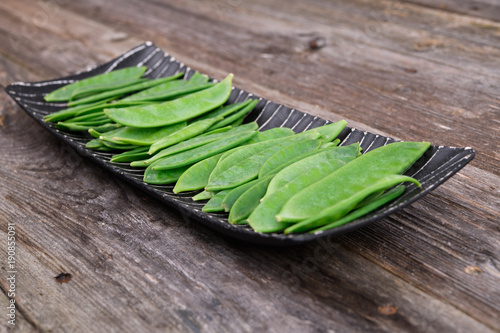 elongated bowl with green peapods photo