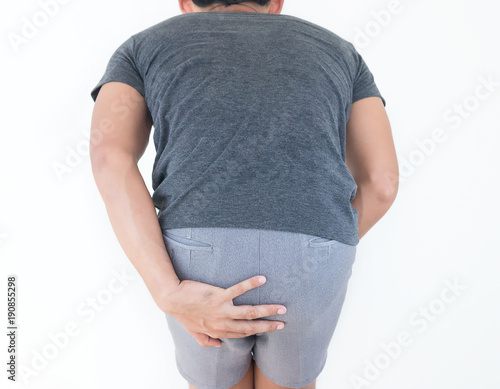 Young man has pain in the butt, Hemorrhoids, Anal disorders.
