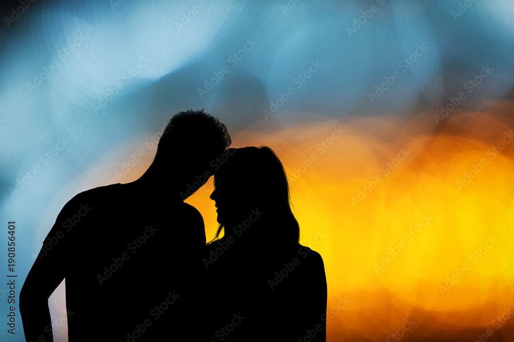 Silhouette of a couple with de-focused / bokeh lights.