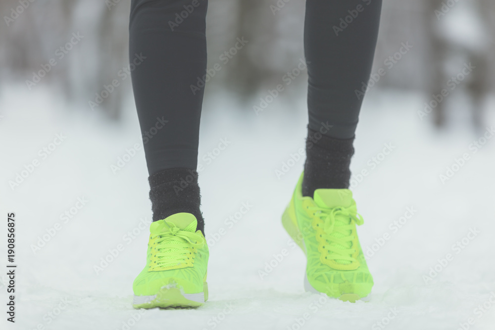 Man exercising and running outdoors on a snow. Shallow depth of field. Man exercising and running outdoors on a snow. Shallow depth of field.