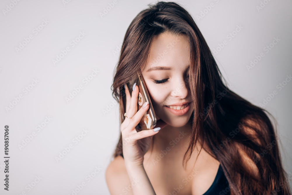Girl calling on phone. Beautiful woman uses a smartphone Girl calling on phone. Beautiful woman uses a smartphone
