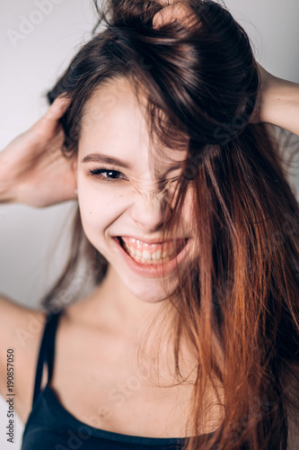 Crazy emotional girl on white background. Portrait of a beautiful young smiling woman.