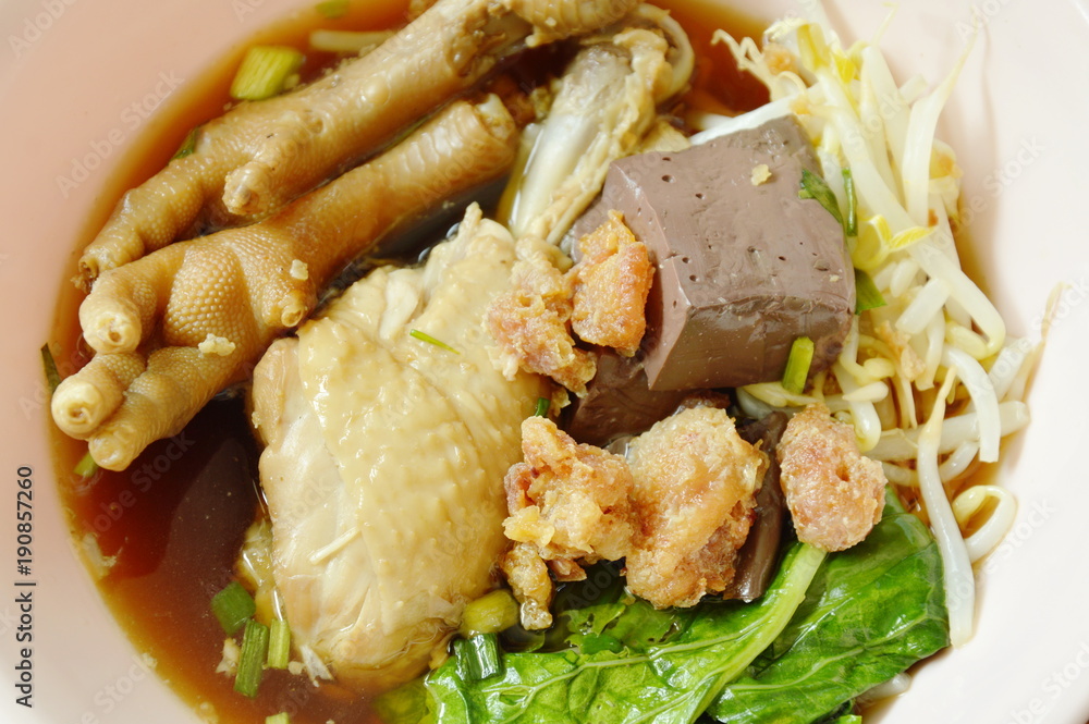 braised chicken leg and feet with bean sprout in herb brown soup on bowl braised chicken leg and feet with bean sprout in herb brown soup on bowl