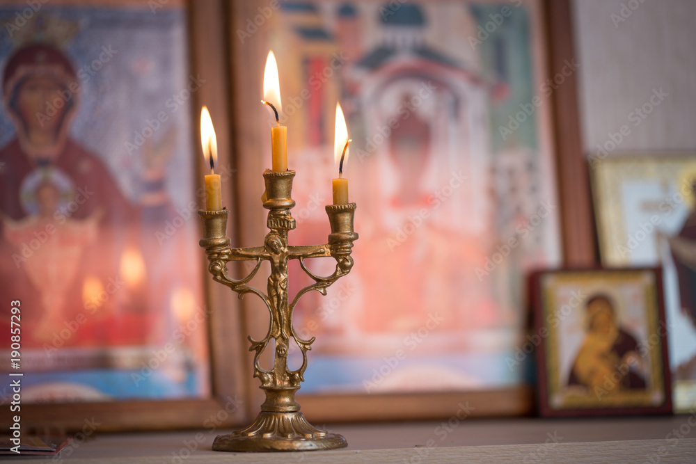 candle against the background of orthodox icons candle against the background of orthodox icons